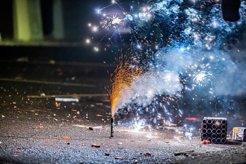 Burnt off fireworks are lying on the street, firecracker smoke produces smoke. New Year's night on