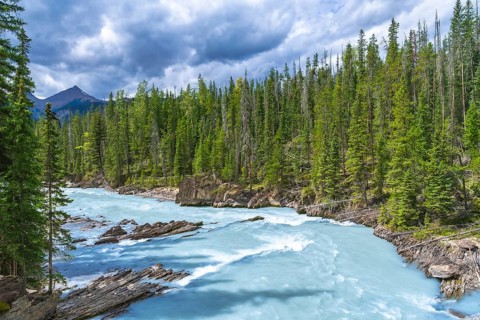 Turquoise water flows through the bow river natural bridge in banff national park, alberta, canada,