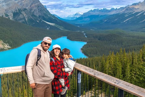 Tourists admiring stunning turquoise waters of peyto lake, surrounded by majestic canadian rockies