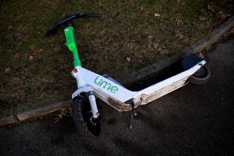 Carelessly left on the side of the road, e-scooter, scooter, in the bike rental company Lime,