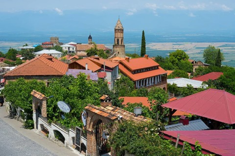 City view with church tower and red roofs under blue sky, Church of St. George, Sighnaghi, Signagi,