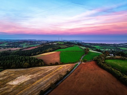 Sunset of Devon Farms and Fields over Berry Pomeroy from a drone, Totnes, England, United Kingdom