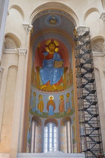 Interior view of a church with tall domes and magnificent frescoed icon paintings, Sameba