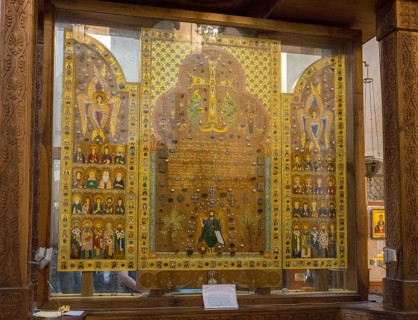 Icons and sacred symbols in an intricately designed glass display case in a church, Sameba