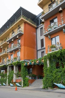 Multi-storey residential building with colorful facades, balconies and lots of greenery, Brim