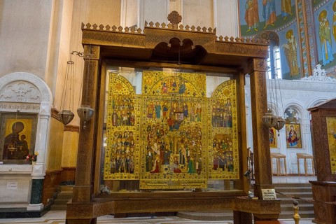 An elaborate icon shrine with detailed sacred representations in the church interior, Sameba