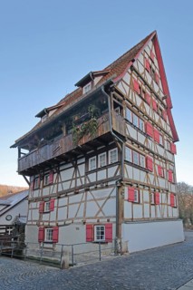 Historic half-timbered house Hoher Will built in 1697 with red shutters, multi-storey, Achgasse,