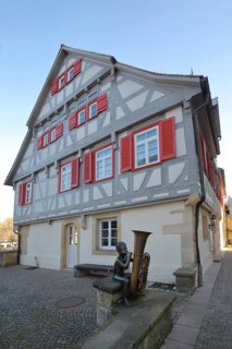 Sculpture boy with tuba by Guido Messer 1991, music school, half-timbered house, making music,