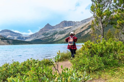 Female tourist enjoying the breathtaking view of bow lake and bow glacier in banff national park,