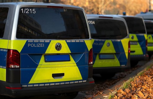 Various police vehicles, police cars, police vans, from behind, parked, Stuttgart,