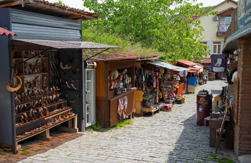 Market street with cobblestones and various souvenir stalls under trees, Mtskheta, Mtskheta,