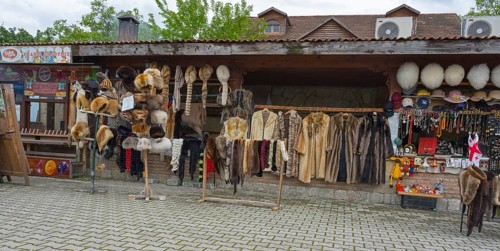Market stall with fur hats and coats surrounded by souvenirs and traditional style, Mtskheta,