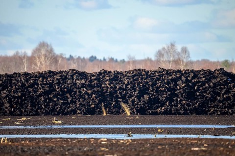 Layered peat sods Peating of a high-moor black peat in cloudy skies with earthy colors and natural