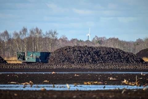 Layered peat sod Peeling of a high-moor black peat in cloudy skies with earthy colors and natural