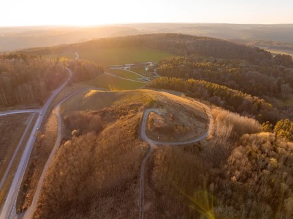 Landscape at sunset with hills and dense forest, future PV building on old deposit, Lindenrain
