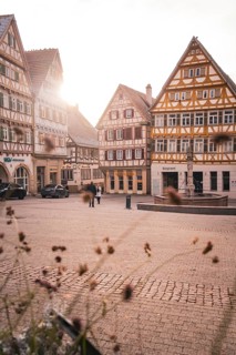 Historic old town with half-timbered houses and warm rays of sunshine on a quiet square,