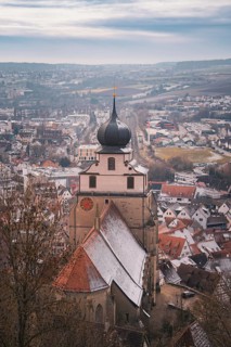 Panorama of the city with a church tower standing in the foreground and winter atmosphere,