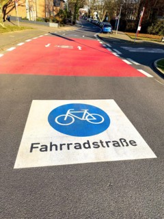 Large marking on road painted symbol for road signs 244.1-40 Start end of a bicycle road, behind it