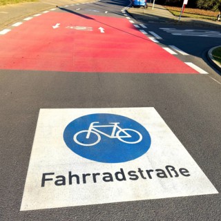 Large marking on road painted symbol for road signs 244.1-40 Start end of a bicycle road, behind it
