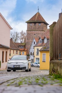 Picturesque alley in the old town with cobblestones and defensive towers, ID3, deer e-car sharing,