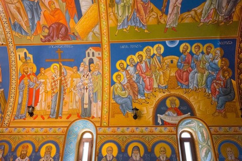 Frescoes in an Orthodox church depict saints and religious scenes in bright colors, St. Barbara