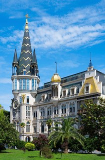 Tower with golden dome in an impressive building with palm trees, Astronomical Clock, Black Gold