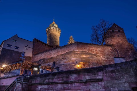 Illuminated Sinwell Tower, built in the 13th century, in the evening sky, Kaiserburg, Nuremberg,