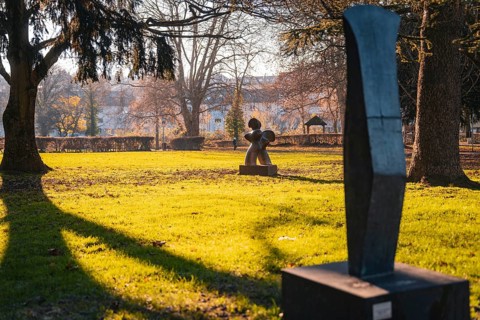Sculptures on a sunny green area in the park in autumn, Stadtgarten Pforzheim, Germany