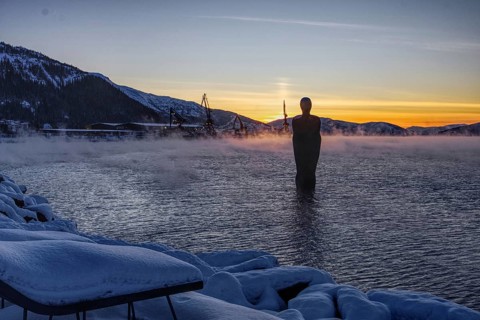 Statue (Havmannen) in the water at sunset with vapour mist, Mo i Rana, Norway