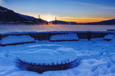Snowy harbor at sunset, overlooking the water, Mo i Rana, Norway