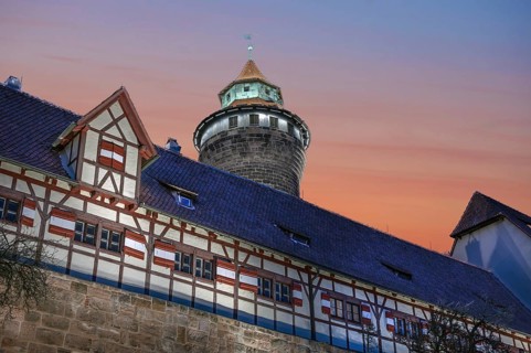 Sinwell Tower built in the 13th century, on the Nuremberg Kaiserburg in the evening lighting, red