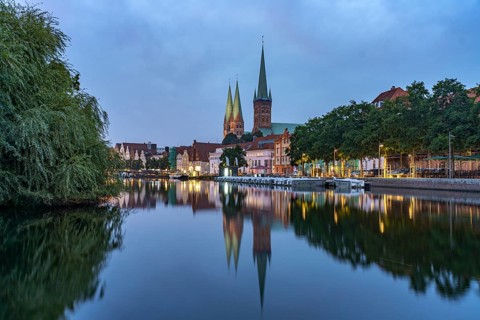 Old town with St. Mary's Church and St. Peter's Church and the Trave at dusk, Lübeck,