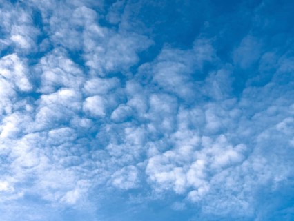 Medium-height white clouds of Altocumulus in blue sky, international