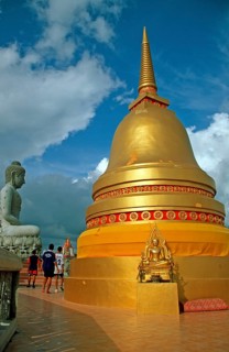 People, Buddha statue, chedi in Wat Tam Sua monastery, which is partly on the top of a mountain,