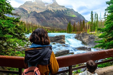 Tourists are enjoying the breathtaking view of athabasca falls, a powerful waterfall located in