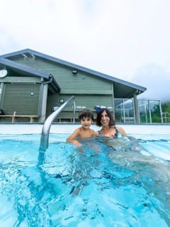 Mother and son are relaxing in a hot spring at miette hot springs in jasper national park, alberta,