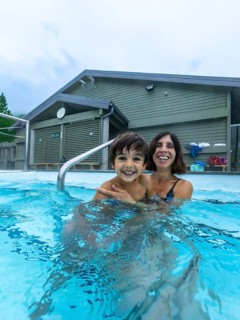 Mother and son are smiling and having fun while bathing in miette hot springs, located in the