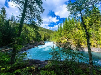 Majestic overlander falls cascading into the vibrant turquoise waters of the fraser river,