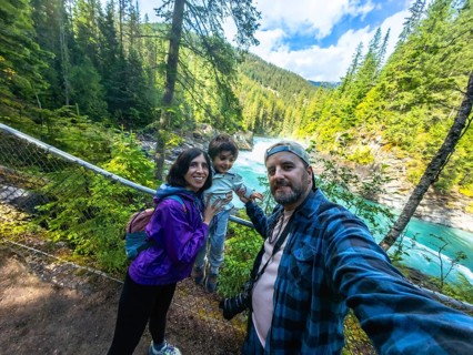 Family taking a selfie against the stunning backdrop of turquoise waters cascading over overlander