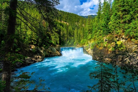Majestic overlander falls cascading into the vibrant turquoise waters of the fraser river,