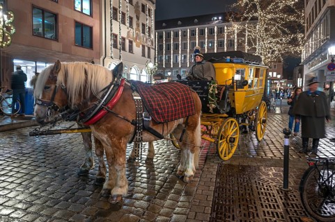 Horse-drawn carriage ride in a historic stagecoach at Chriskindlesmarkt, Hauptmarkt, Nuremberg,