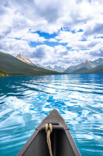 Canoe sailing on the turquoise waters of maligne lake with a stunning view of the canadian rockies