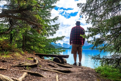 Tourist is enjoying the stunning scenery of turquoise maligne lake and surrounding mountains in