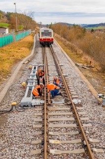 Workers carry out maintenance work on railroad tracks, historic event, first test run with a