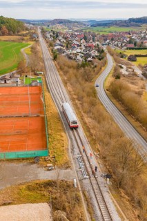 Overview of train travel along tennis courts on the outskirts of the city, historical event, first