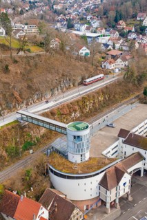 Architecture and a train on an elevated position with a view of houses and other buildings,
