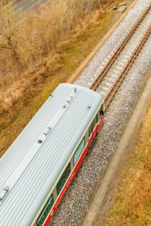 A train travels along the tracks through an autumn landscape. The sky is cloudy, historic event,