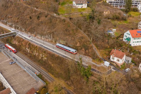 Zug moves through a varied landscape of hills and buildings in a wintry atmosphere, historic event,