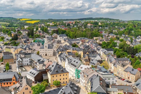 View from St. Wolfgang church of the town of Schneeberg with historic houses and town hall, Ore