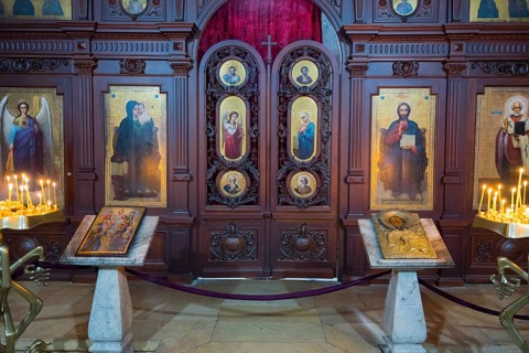 A church interior with ornate icons, altars and burning candles, Svetitskhoveli Cathedral,
